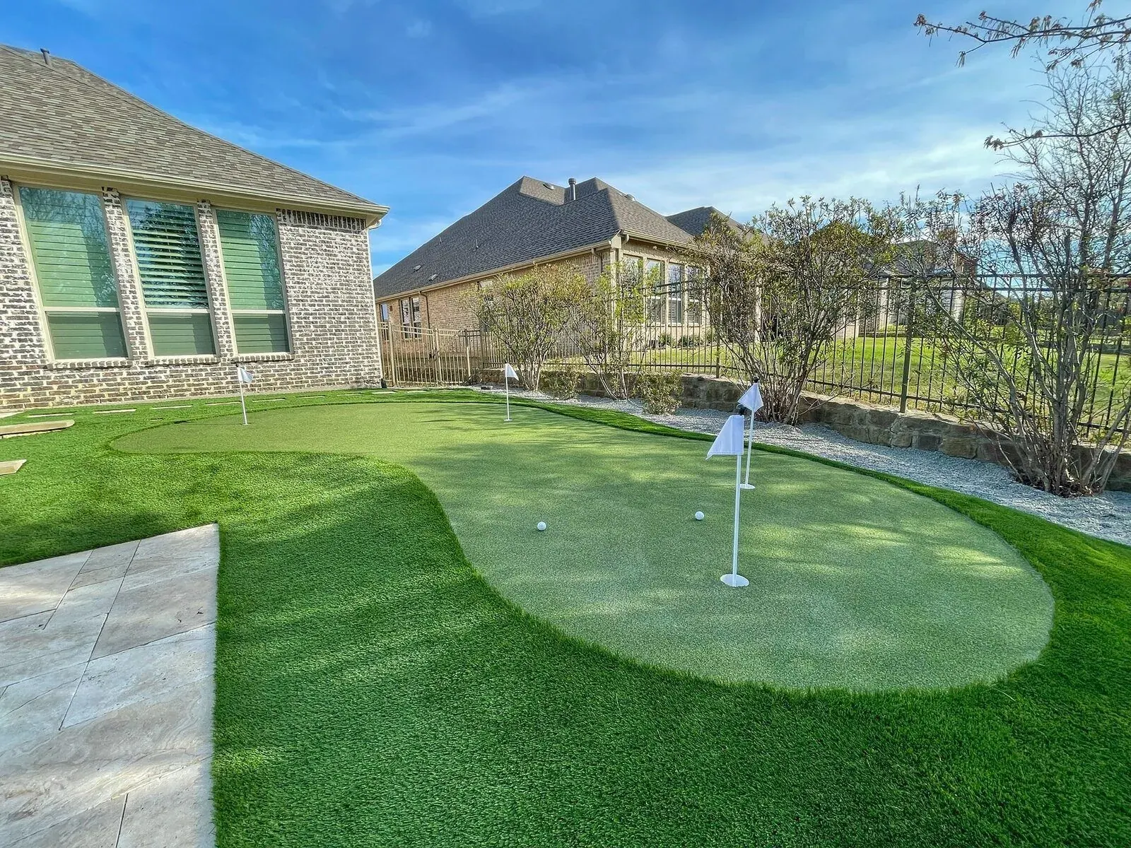 Finished backyard putting green and surrounding landscape by Diamond Field Systems