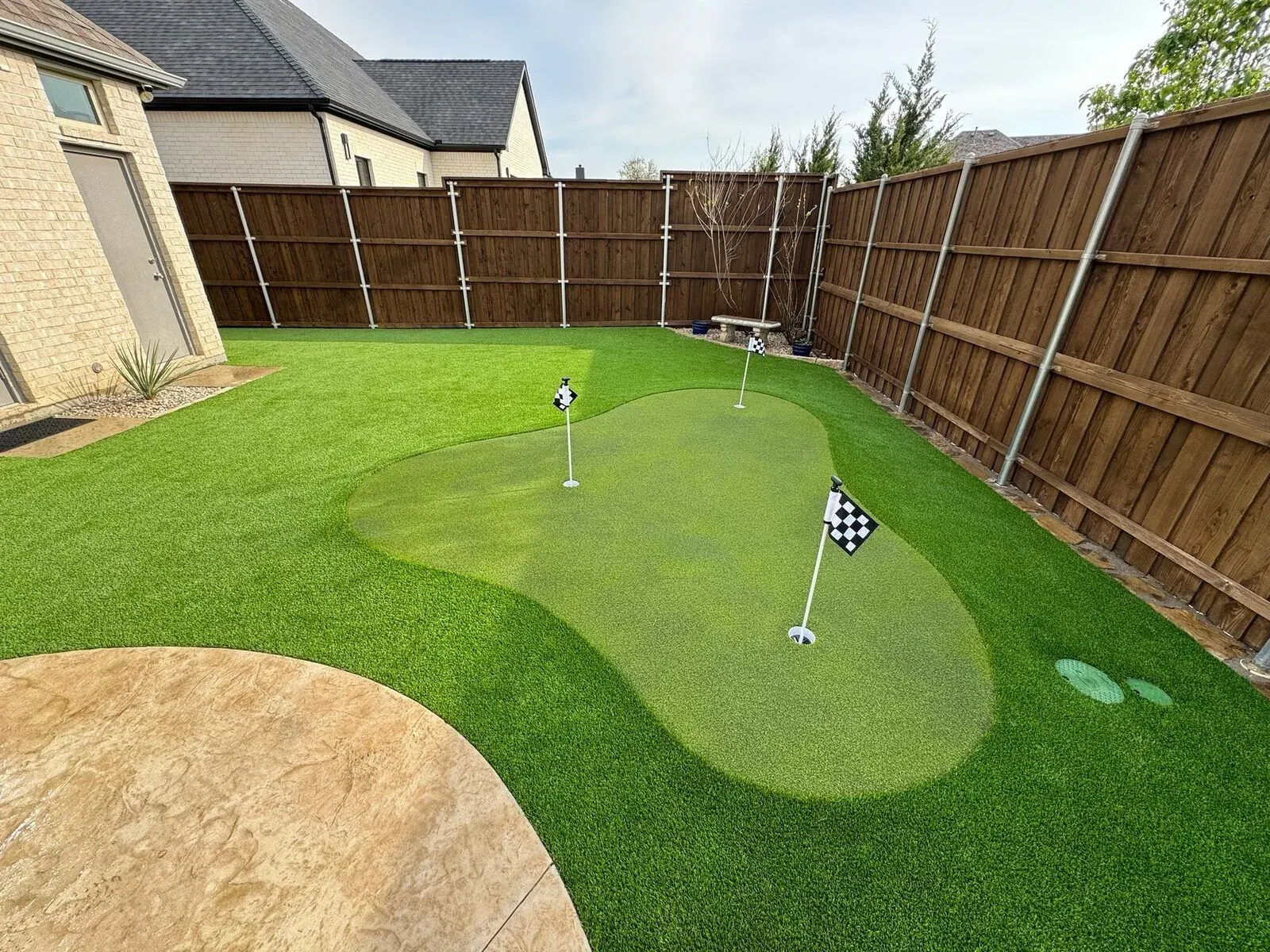 Finished custom putting green with shaped contours and cups by Diamond Field Systems