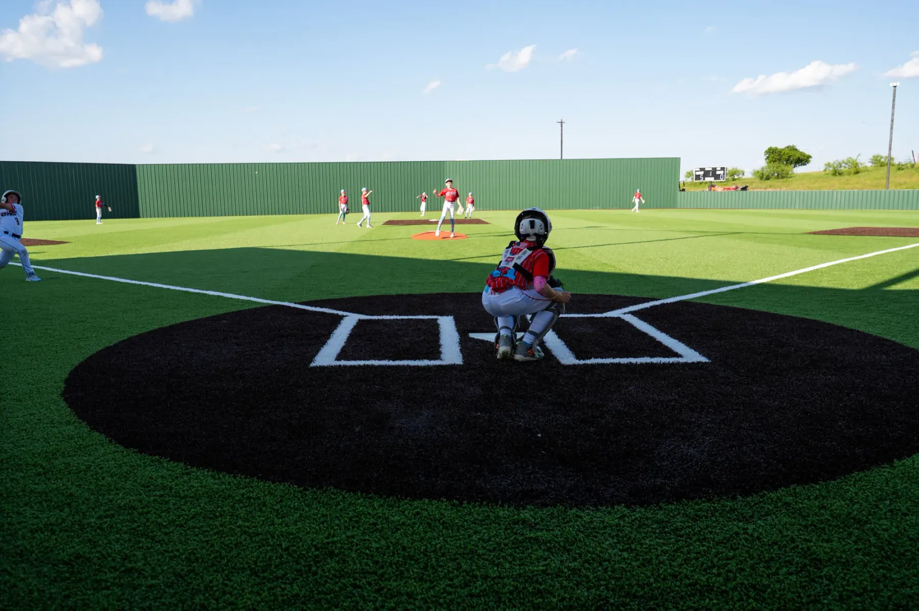 Youth baseball game on an artificial turf field built by Diamond Field Systems